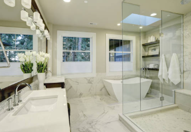 Spa-inspired bathroom with freestanding tub, marble floors, and glass shower